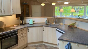 A modern kitchen with a built-in oven, a coffee maker, and a sink. - "Orpah" - 2.5km from the sea by Interhome (Rømø)
