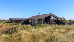A modern house with a sloped roof, large windows, and a visible satellite dish. - "Alim" - 300m from the sea by Interhome (Rømø)