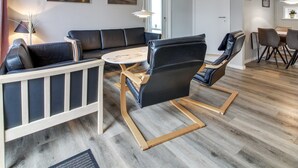 A modern living room with a sofa, chairs, a coffee table, and a dining area. - "Anouk" - 1.7km from the sea by Interhome (Rømø)