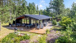 A modern cabin with a covered patio, surrounded by dense forest. - "Santuzza" - 3.9km from the sea by Interhome (Rømø)