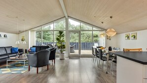 A spacious living area with a large window, a dining area, and a kitchen. - "Lav" - 3.8km from the sea by Interhome (Rømø)