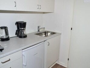 Enjoy cooking in this fully equipped kitchenette with a stainless steel sink and coffee maker.