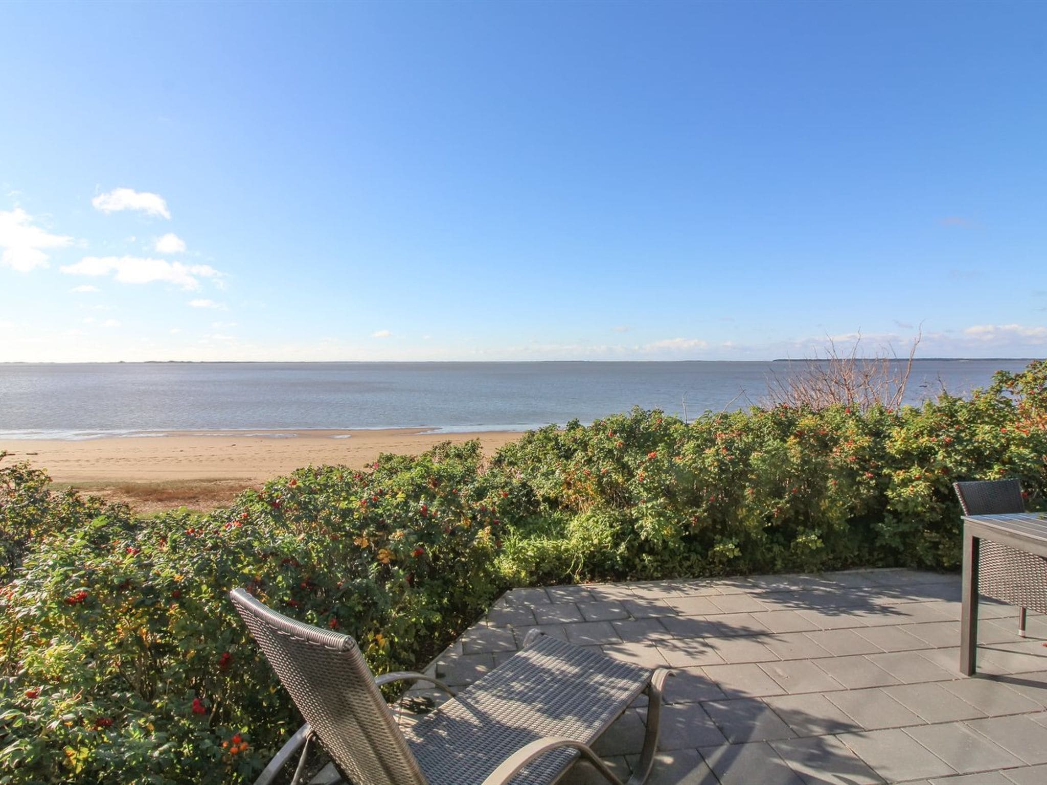 Une terrasse avec vue sur la plage et l’océan.