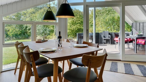 A dining area with a large table, chairs, and pendant lights. - "Gram" - 450m from the sea by Interhome (Sydals)
