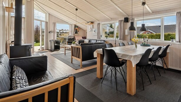 A spacious living area with a large wooden table, black chairs, and a sofa. - "Tjakko" - 900m from the sea by Interhome (Sydals)