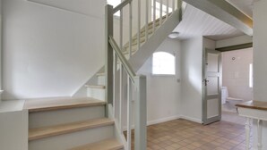 A staircase with wooden steps and a white railing leading to an upper floor. - "Ingulf" - 18km from the sea by Interhome (Bredebro)