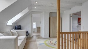 A modern, well-lit room with a white ceiling, a wooden floor, and a white sofa. - "Juuso" - 20km from the sea by Interhome (Bredebro)
