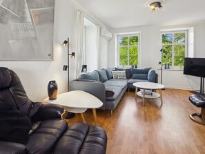 A modern living room with a leather sofa, a white coffee table, and a grey couch. - "Juuso" - 20km from the sea by Interhome (Bredebro)