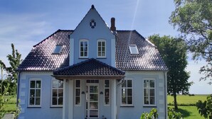 A two-story house with a tiled roof, a front porch, and a small garden area. - "Juuso" - 20km from the sea by Interhome (Bredebro)