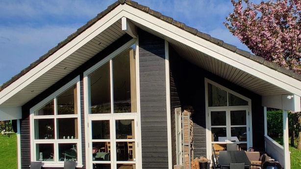 A modern house with large windows, a deck with outdoor furniture, and a barbecue area. - "Holmwith" - 200m from the sea by Interhome (Aabenraa)