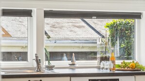 A kitchen with a window view, a sink, and a dishwasher. - "Fiete" - 200m from the sea by Interhome (Bjert)