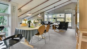 A spacious dining area with a high ceiling, wooden beams, and large windows. - "Roel" - 500m from the sea by Interhome (Tranekær)