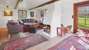 A cozy living room with a fireplace, a sofa, a coffee table, and a rug. - "Elvin" - 2.7km from the sea by Interhome (Humble)