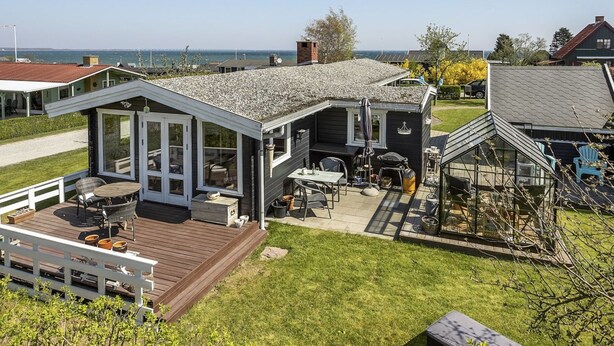 A house with a deck, outdoor seating, and a view of the sea. - "Ylvie" - 150m from the sea by Interhome (Frørup)