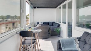 A balcony with a sofa, chairs, and a table. - "Constance" - 50m from the sea by Interhome (Svendborg)