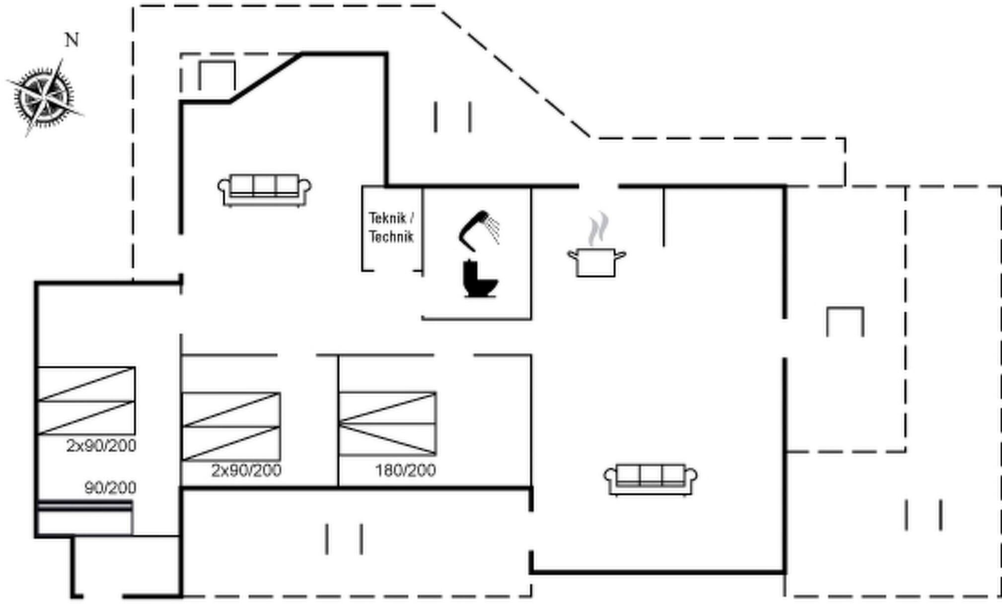 A floor plan with a kitchenette, two bathrooms, and a living area with a sofa.