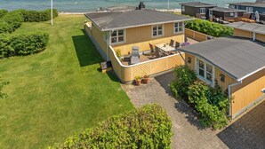 A coastal vacation home with a patio, a small deck, and a view of the ocean. - "Hwitserk" - 5m from the sea by Interhome (Otterup)