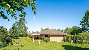 A single-story house with a red-tiled roof, a covered patio, and a well-maintained lawn. - "Maleen" - 150m to the fjord by Interhome (Nakskov)