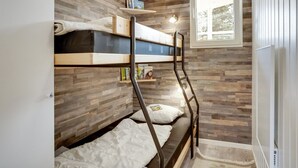 A bunk bed room with wooden walls, a window, and a ladder. - "Sanna" - 330m from the sea by Interhome (Væggerløse)