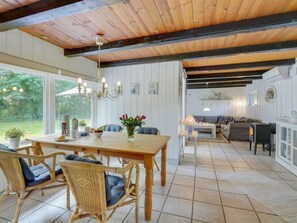 Enjoy a spacious interior with a high ceiling, dining area, and cozy living space.