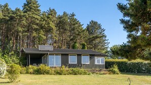 A modern house with a sloped roof, large windows, and a covered porch area. - "Miona" - 725m from the sea by Interhome (Kalundborg)