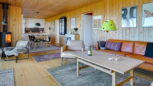 A cozy living room with a sofa, a dining area, and a kitchen. - "Iadrik" - 85m to the fjord by Interhome (Skibby)