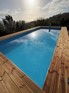 Seasonal outdoor pool, open 9:00 AM to 6:30 PM, pool umbrellas