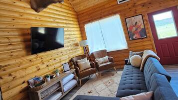 Cabin | Living area | 70-inch flat-screen TV with digital channels, fireplace, DVD player