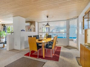 A modern dining area with a wooden ceiling, a large window, and a view of the outdoors. - "Tuula" - 1.1km from the sea by Interhome (Vejers Strand)