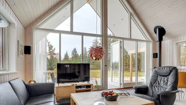 A modern living room with a large TV, leather sofas, a coffee table, and a view of the outdoors. - "Lima" - 3.5km from the sea by Interhome (Rømø)