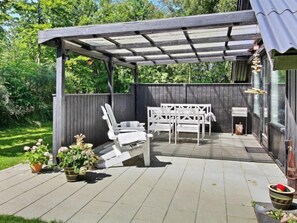 Enjoy dining or socializing in this inviting patio area with a table and chairs.