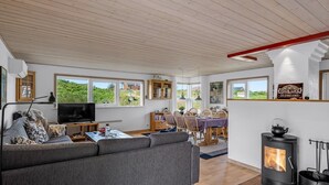 A cozy living room with a sofa, TV, and a fireplace. - "Tedora" - 300m from the sea by Interhome (Fanø)