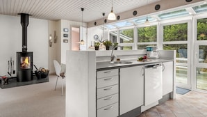 A modern kitchen with a central island, a built-in stove, and large windows. - "Andine" - 1.2km from the sea by Interhome (Fanø)