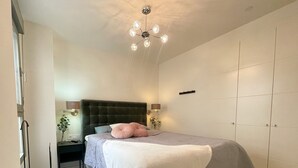 A bedroom with a bed, bedside tables, a lamp, a ceiling light, and a wardrobe. - Apartment "Sunny Panorama" with Sea View, Shared Pool & Wi-Fi (Torrox)