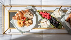 A breakfast tray with croissants, a donut, berries, and a glass of milk on a bed. - Holiday Home 'Mirò' with Private Garden, Wi-Fi & Air Conditioning (NO ZTL) (Lucca)