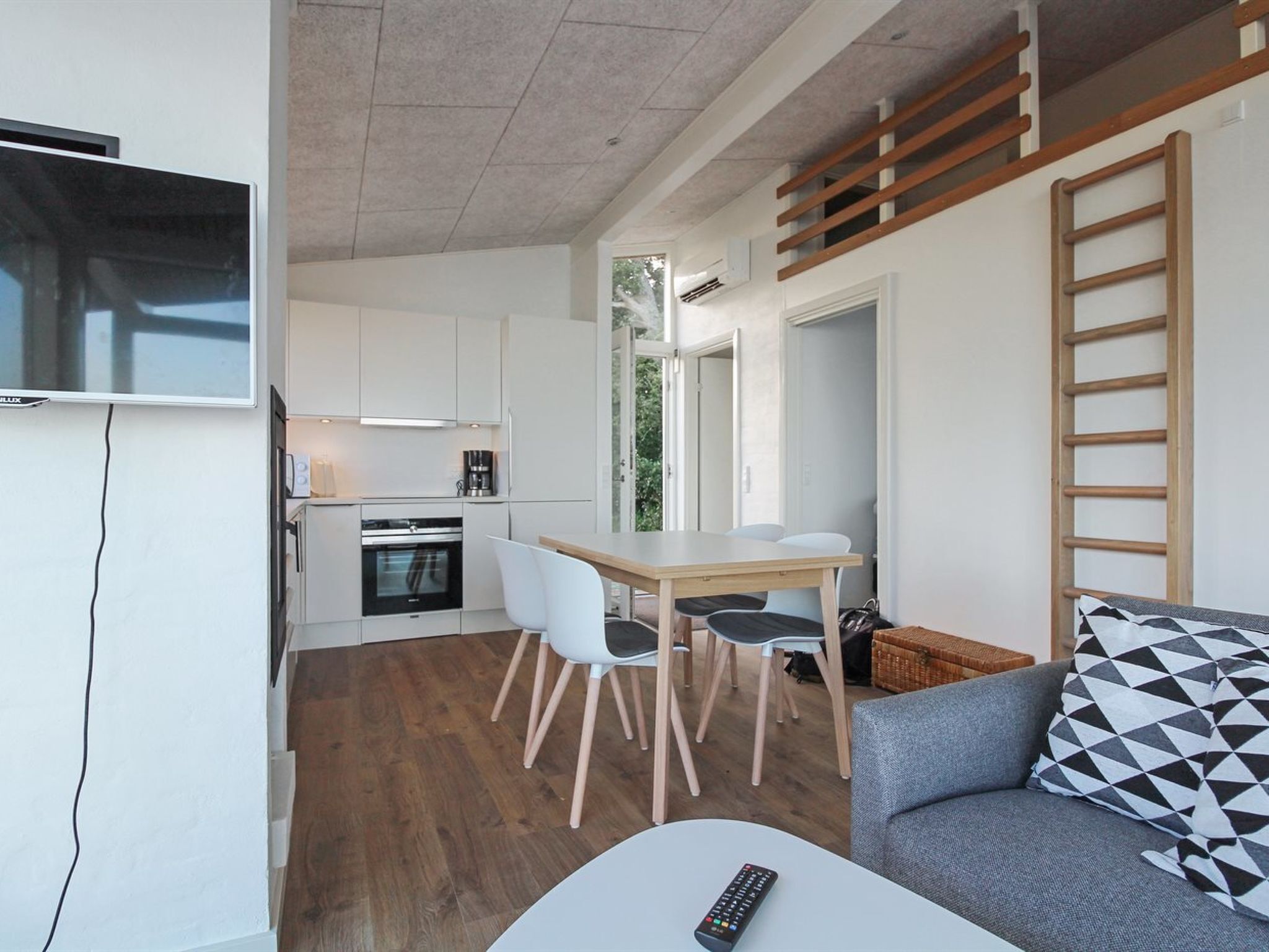 A compact living space with a kitchenette, dining area, and seating area.