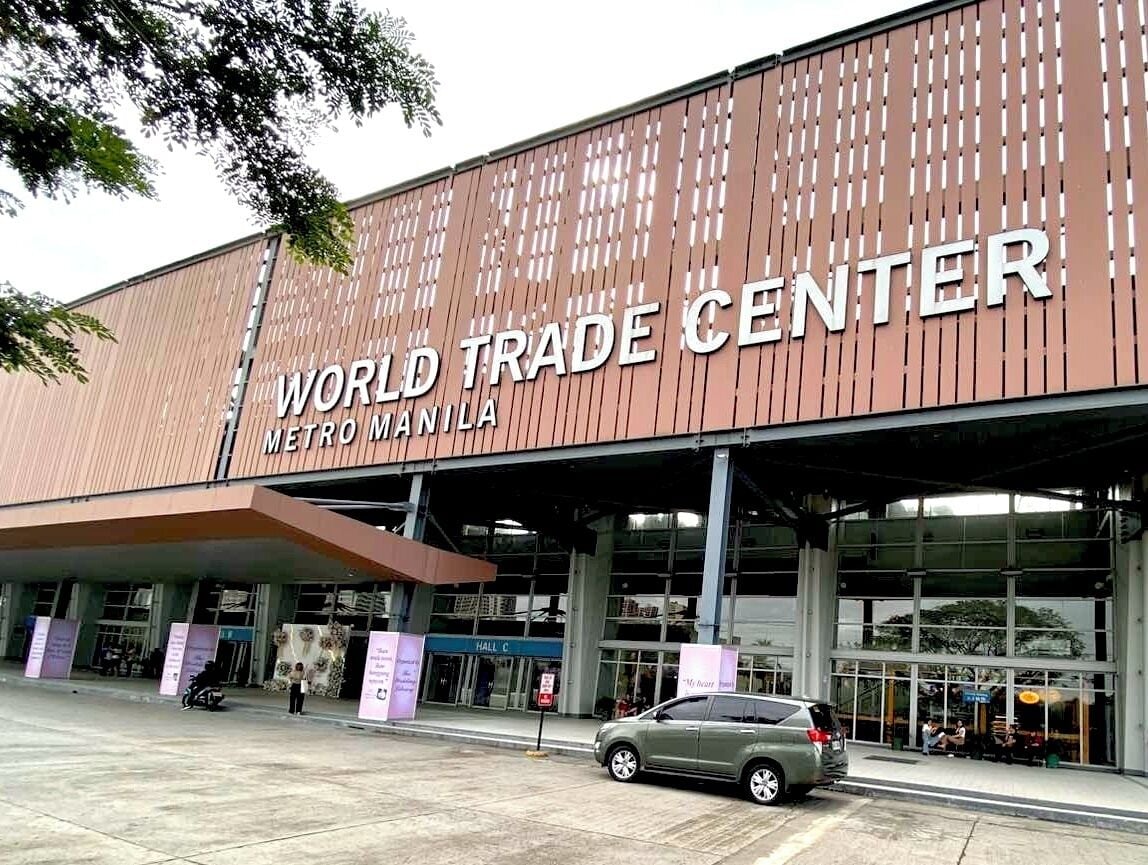 The exterior of the World Trade Center Metro Manila, featuring a modern design with large glass windows and a prominent entrance.