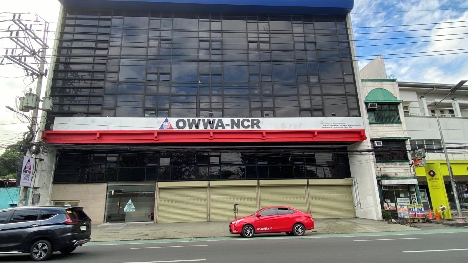A building with a large glass facade and a sign reading "OWWA-NCR".