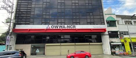 A building with a large glass facade and a sign reading "OWWA-NCR".