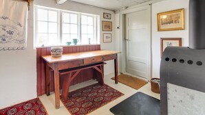 A cozy room with a wooden desk, a window with curtains, a door, and a fireplace. - "Saarah" - 25km from the sea by Interhome (Bredebro)