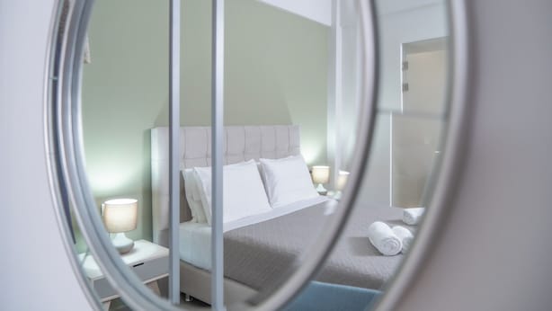 A bedroom with a bed, nightstands, and a mirror. - Villa Emily (Voukolies, Chania)