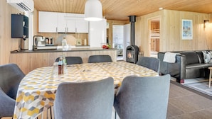 A modern kitchen with white cabinets, a central island, and a black stove. - "Bistra" - 400m from the sea by Interhome (Løkken)
