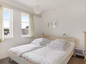 A bedroom with a bed, a window, a painting, and a bedside table. - "Lynne" - 2.3km from the sea by Interhome (Rømø)
