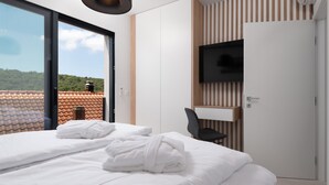 A modern hotel room with two beds, a TV, and a view of the outdoors. - Kala in Razanac With 4 Bedrooms and 2 Bathrooms (Razanac)
