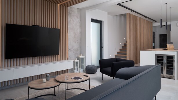 A modern living room with a flat-screen TV, a sofa, a coffee table, and a dining area with a kitchen in the background. - Kala in Razanac With 4 Bedrooms and 2 Bathrooms (Razanac)