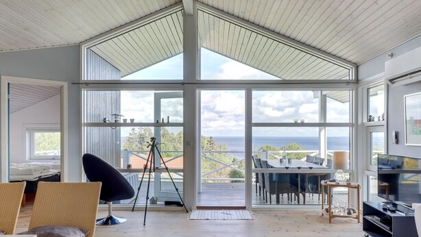 A spacious room with a high ceiling, large windows, a telescope, and a television. - "Tjelle" - 300m from the sea by Interhome (Allinge)