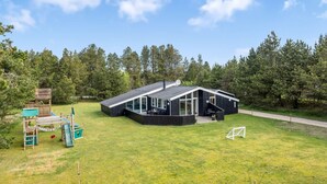 A modern house with a large deck and a play area for children. - "Halwarth" - 250m from the sea by Interhome (Jerup)