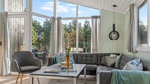 A sunlit room with a grey sofa, a coffee table, and a chair. - "Halwarth" - 250m from the sea by Interhome (Jerup)