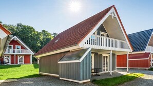 A two-story house with a red roof, a balcony, and a small attached garage. - "Joris" - 100m to the fjord by Interhome (Gråsten)