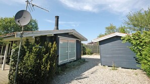 A house with a satellite dish, a chimney, and a garage.